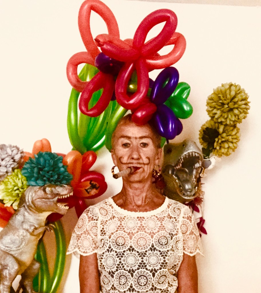Katy headshot with balloons and dinosaurs